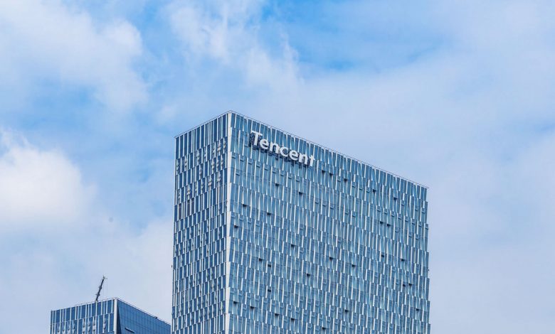 Tencent building, with brand name showing, against clear blue sky for backdrop.