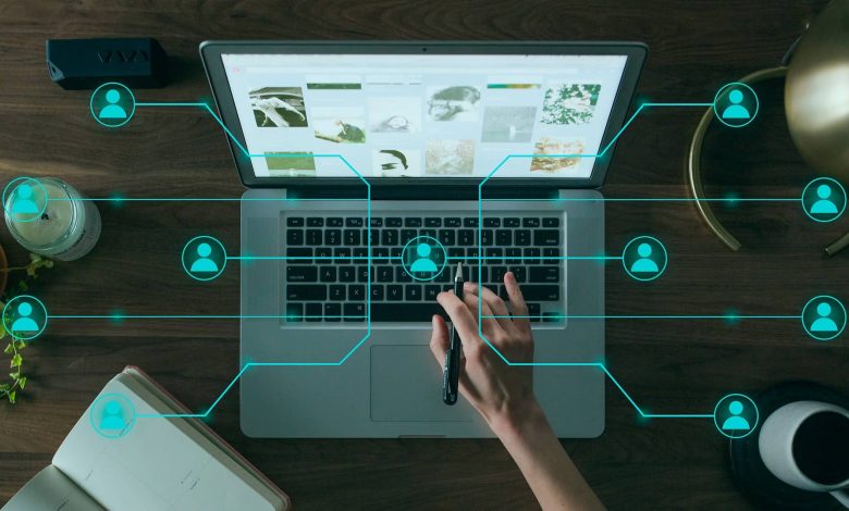 A hand using a laptop with signals in the background