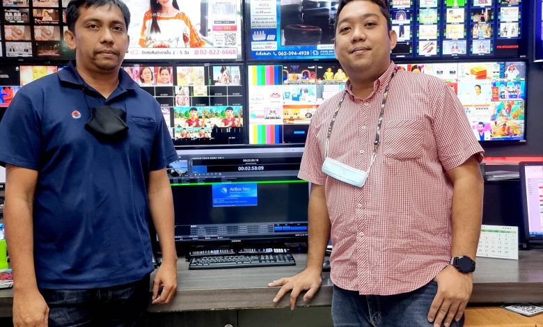 Two men standing in a playout suite