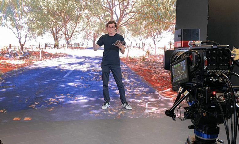 Man stands in front of virtual background