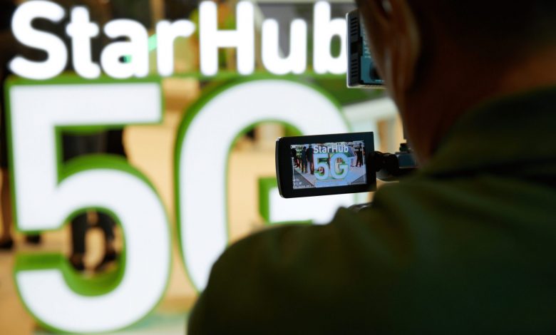 Man filming picture of StarHub 5G logo