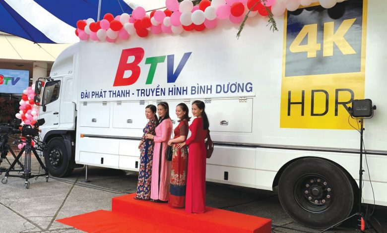 Four women standing in front of a BTV van