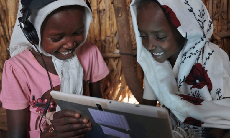 Two African children using a tablet