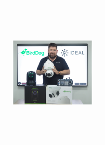 Man in black holding a white equipment