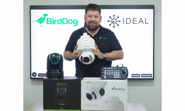 Man in black holding a white equipment